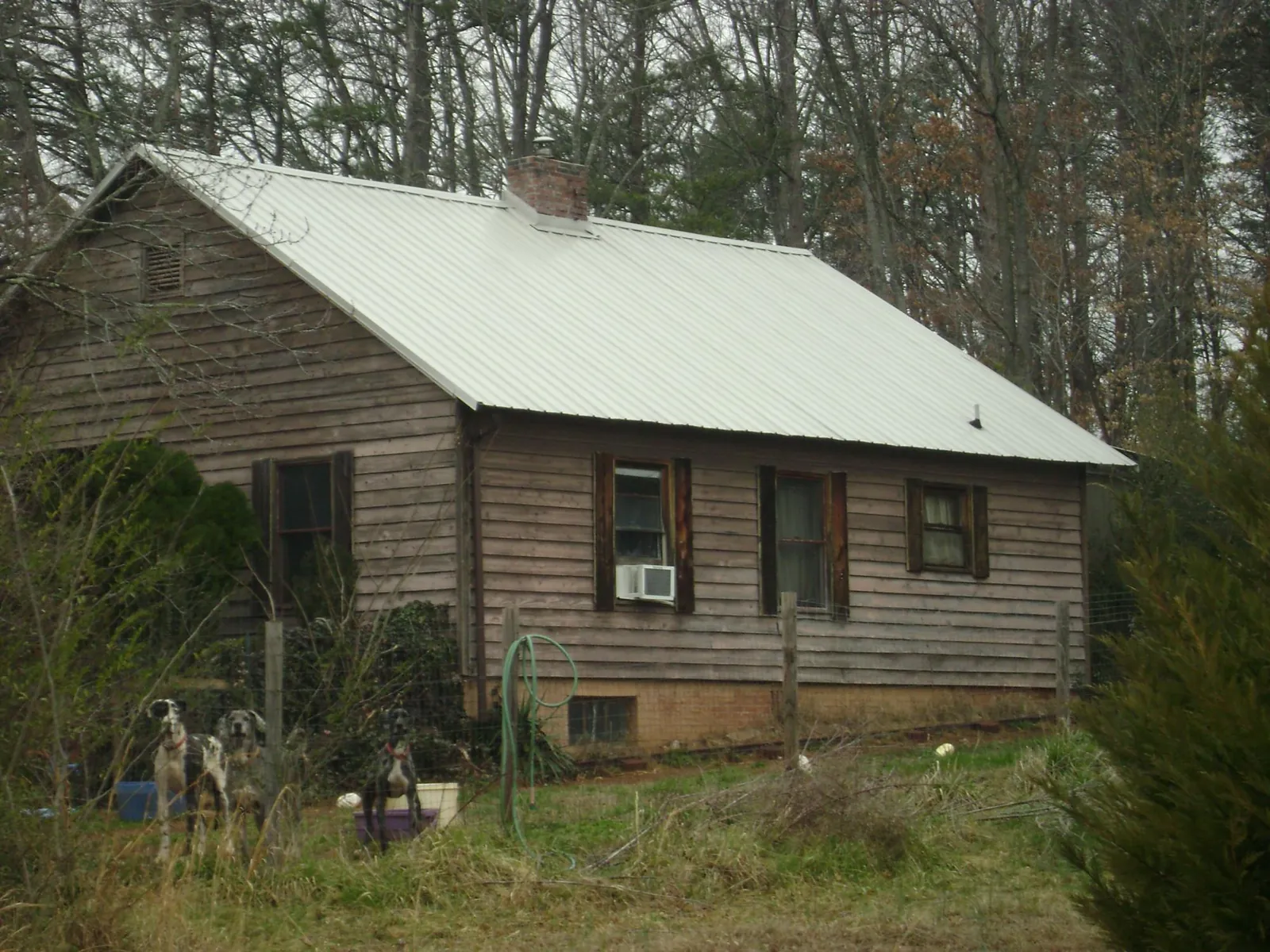 White metal roof on an old wood sided farmhouse, from a Metal Roof Installation job in Brandon
